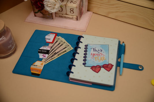 Mini Happy Planner skinny classic cover in pastel design on a desk